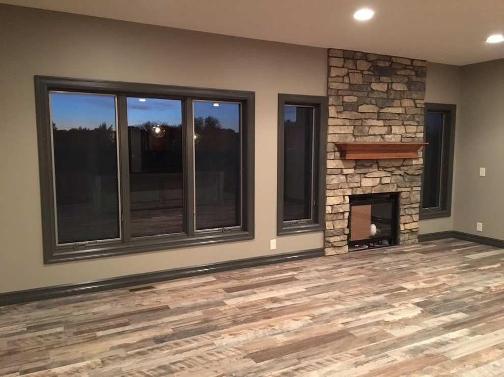 Mid-sized transitional open concept living room in Omaha with beige walls, porcelain floors, a standard fireplace, a stone fireplace surround, no tv and multi-coloured floor.