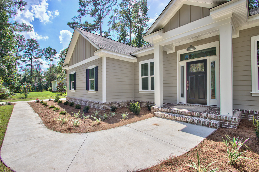 Mid-sized transitional one-storey grey house exterior in Atlanta with wood siding, a gable roof and a tile roof.