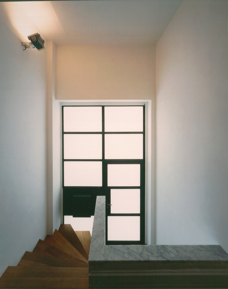 Design ideas for a modern hallway in Frankfurt with white walls and medium hardwood floors.