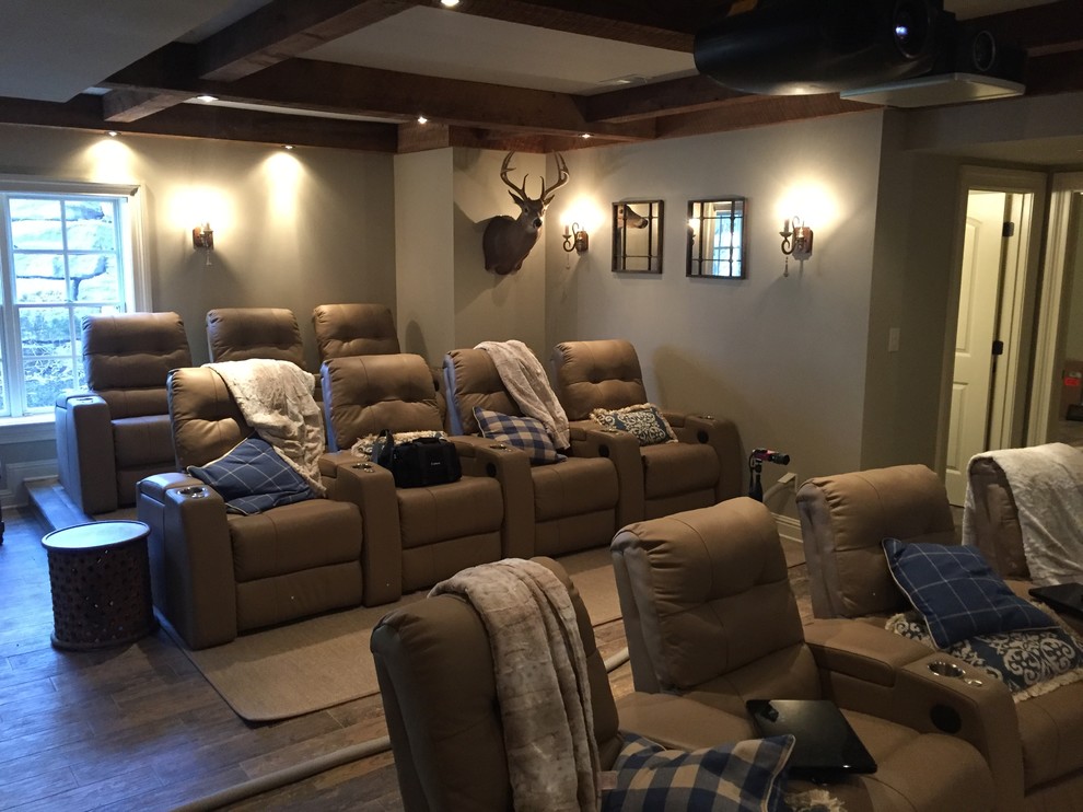 Design ideas for a large country open concept home theatre in Other with grey walls, medium hardwood floors, a projector screen and brown floor.