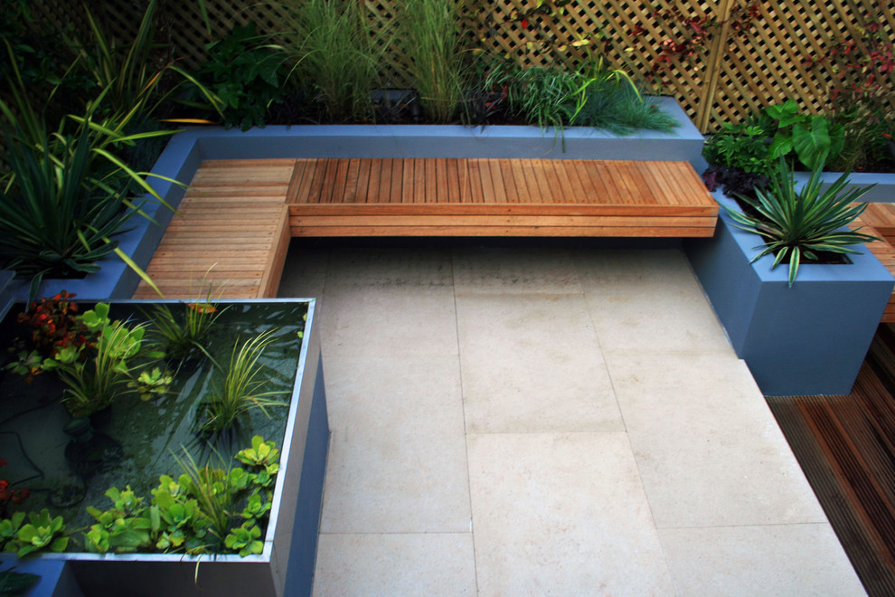 Design ideas for a small contemporary backyard patio in London.