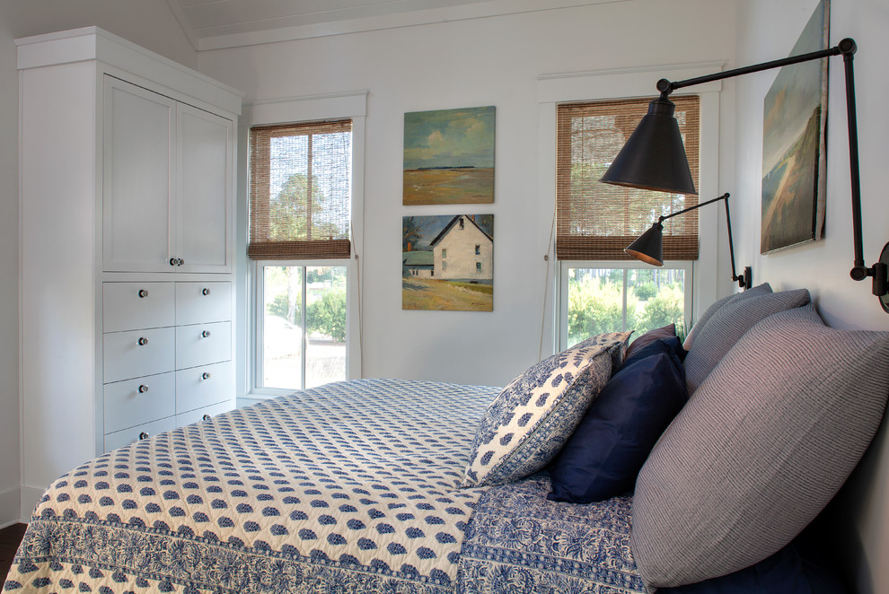Country bedroom in Philadelphia with white walls, dark hardwood floors and brown floor.