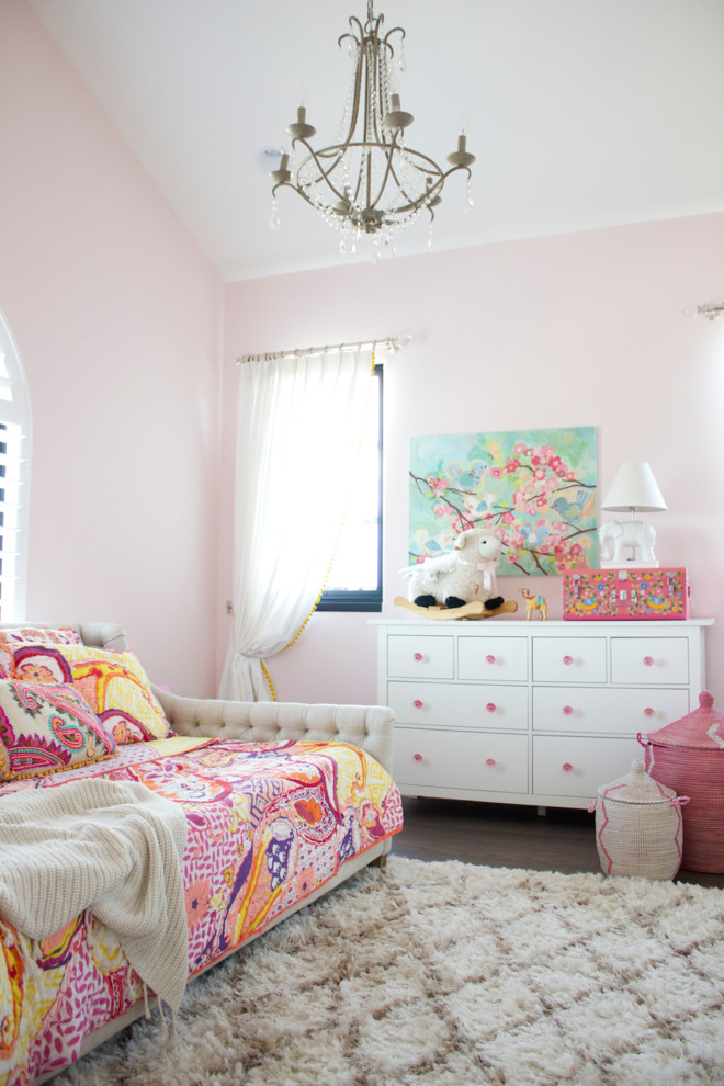 Design ideas for a transitional kids' bedroom for kids 4-10 years old and girls in Austin with pink walls.