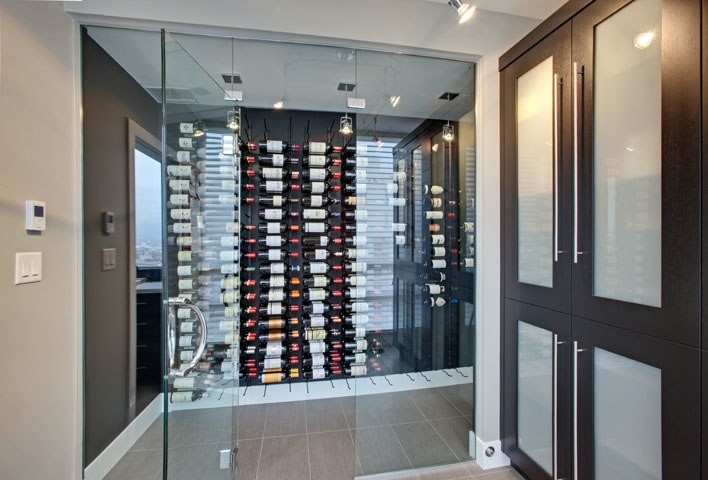 This is an example of a mid-sized contemporary wine cellar in Vancouver with ceramic floors and storage racks.