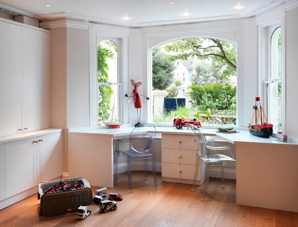 Inspiration for a transitional home office in London with a built-in desk.