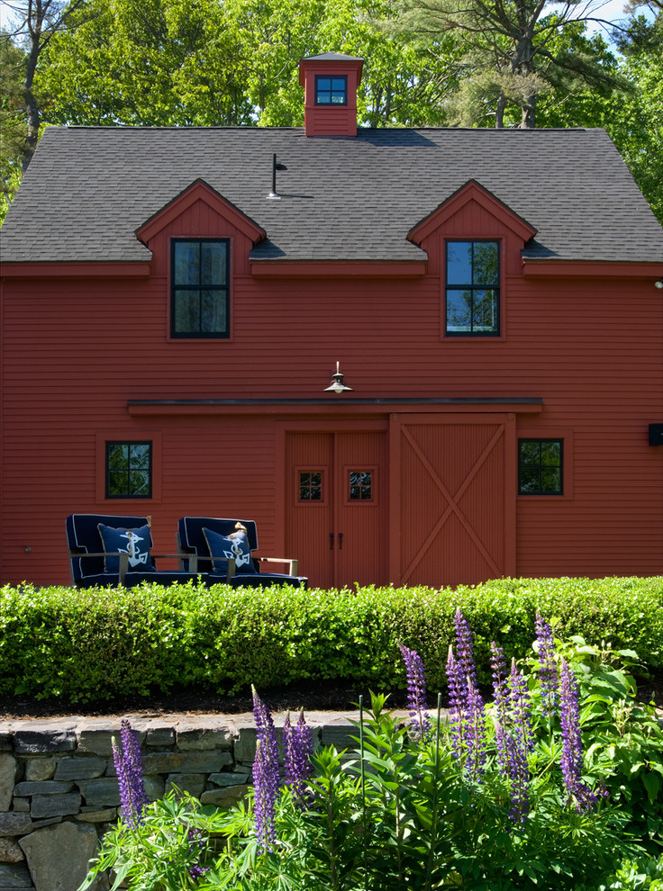 Inspiration for a country two-storey red exterior in Other with wood siding.