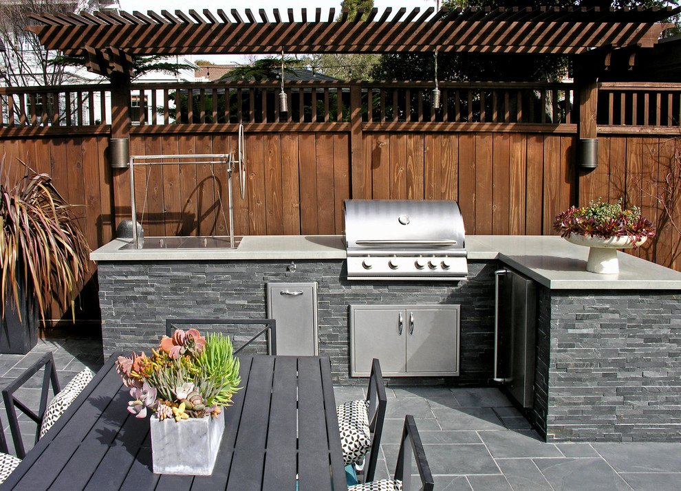 Large arts and crafts backyard full sun xeriscape in San Francisco with natural stone pavers.