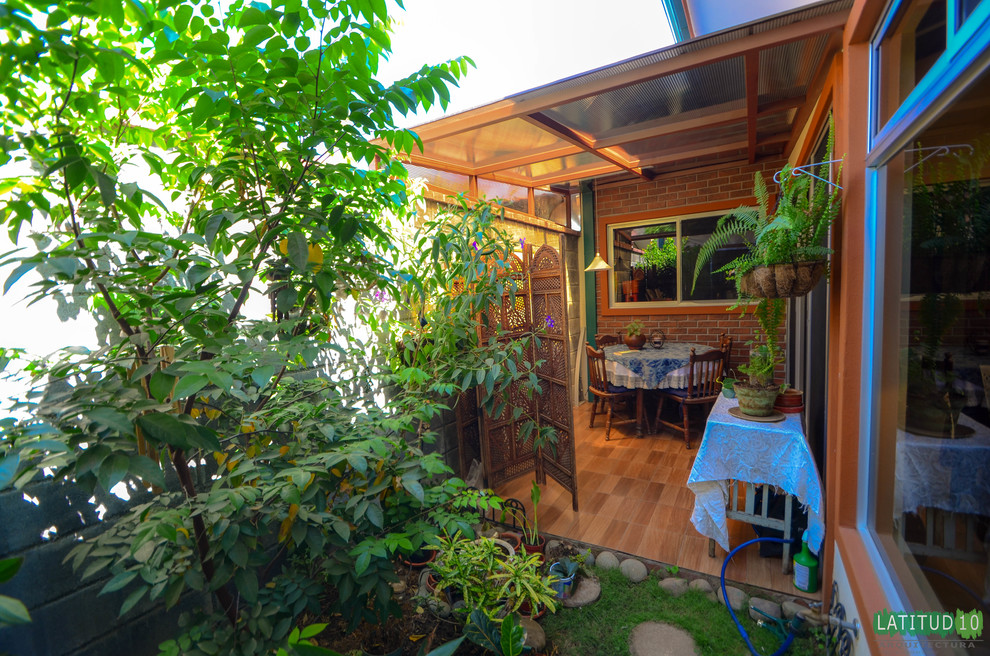 Small mountain style backyard stone home design photo with a gazebo