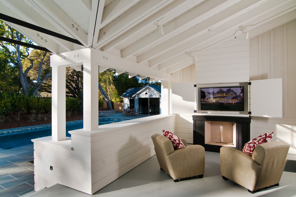 Photo of a country verandah in San Francisco with a fire feature, decking and a roof extension.