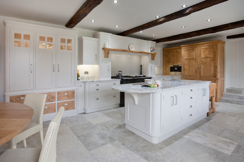 Inspiration for an expansive country kitchen in Other with an undermount sink, shaker cabinets, white cabinets, granite benchtops, white splashback, glass sheet splashback, black appliances and with island.