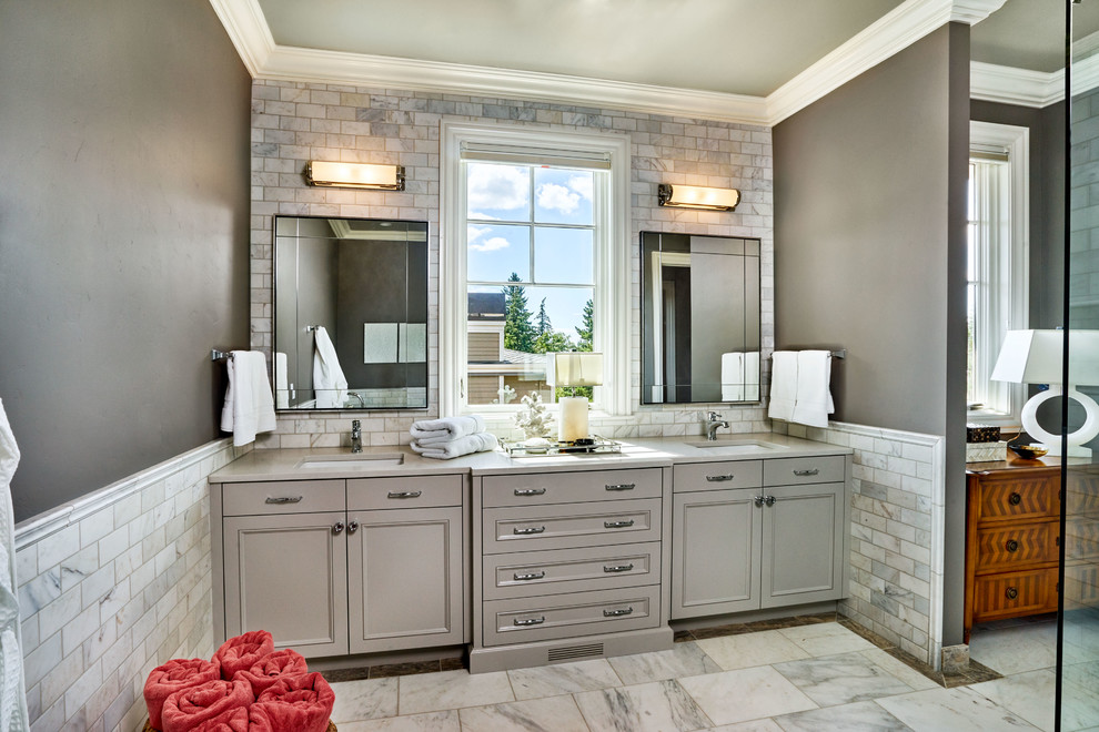 This is an example of a mid-sized traditional master bathroom in Portland with recessed-panel cabinets, grey cabinets, a claw-foot tub, a corner shower, gray tile, stone tile, grey walls, marble floors, an undermount sink and engineered quartz benchtops.
