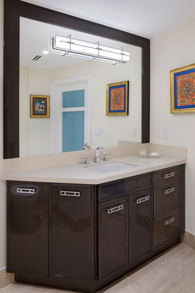 Mid-sized transitional 3/4 porcelain tile and beige floor bathroom photo in Miami with recessed-panel cabinets, brown cabinets, a one-piece toilet, beige walls, an undermount sink, solid surface countertops and beige countertops