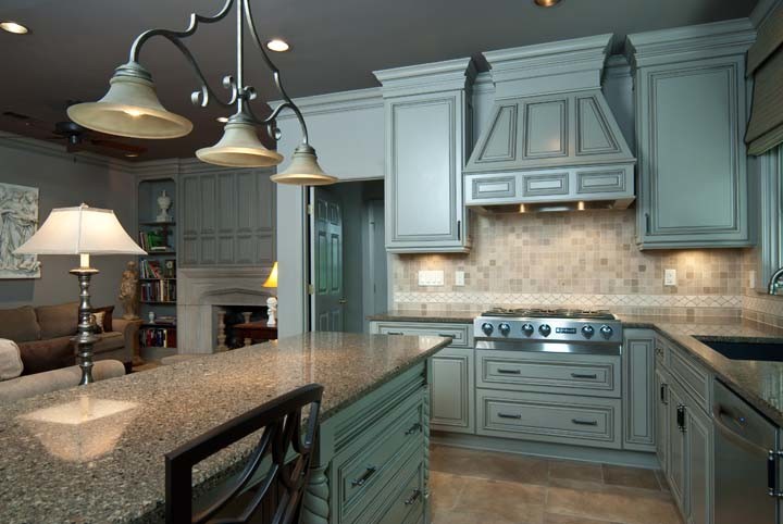 Example of a small l-shaped ceramic tile eat-in kitchen design with a single-bowl sink, flat-panel cabinets, gray cabinets, granite countertops and stainless steel appliances