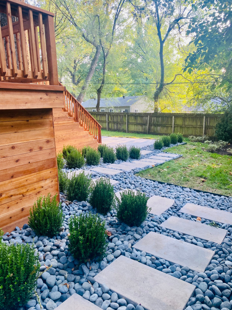 This is an example of a modern back garden in Kansas City with a fire feature and concrete paving.