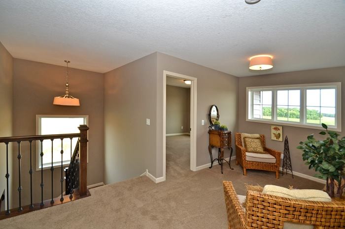 Inspiration for a mid-sized transitional carpeted hallway remodel in Minneapolis with beige walls