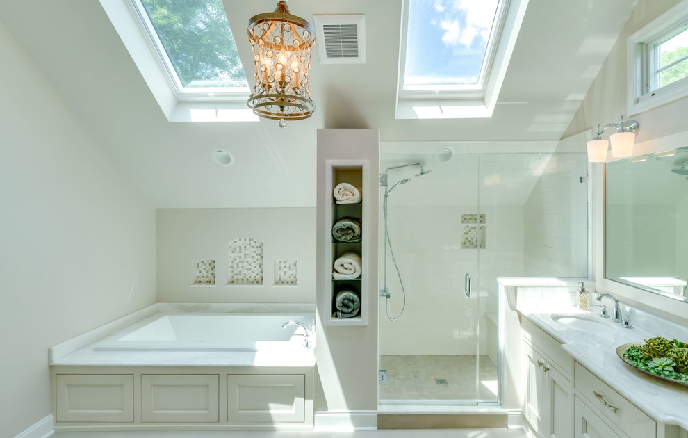 Large transitional master bathroom in Philadelphia with recessed-panel cabinets, white cabinets, a drop-in tub, a corner shower, a two-piece toilet, white tile, stone slab, white walls, ceramic floors, an undermount sink, quartzite benchtops, white floor and a hinged shower door.