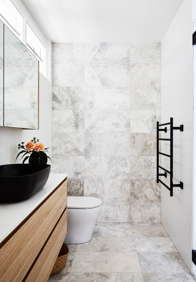 Inspiration for a small contemporary bathroom in Sydney with flat-panel cabinets, light wood cabinets, an alcove shower, a one-piece toilet, marble, marble floors, a vessel sink, engineered quartz benchtops, grey floor, a hinged shower door, white benchtops, a single vanity and a floating vanity.