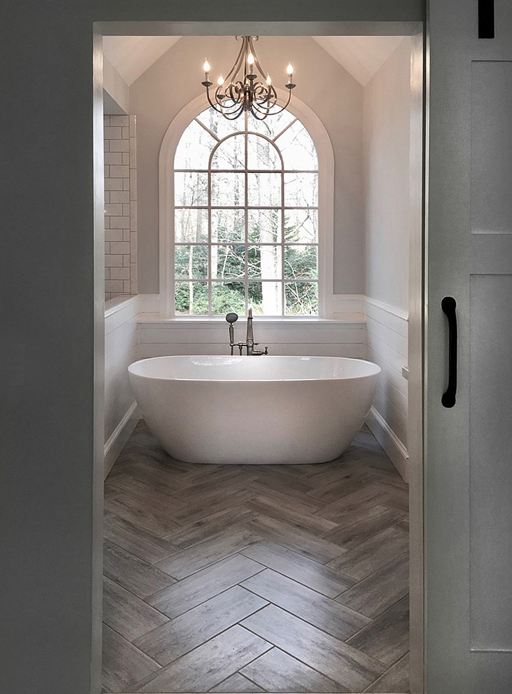 Design ideas for a mid-sized country master bathroom in Atlanta with shaker cabinets, grey cabinets, a freestanding tub, a corner shower, a two-piece toilet, white tile, ceramic tile, grey walls, ceramic floors, an undermount sink, marble benchtops, grey floor and a hinged shower door.
