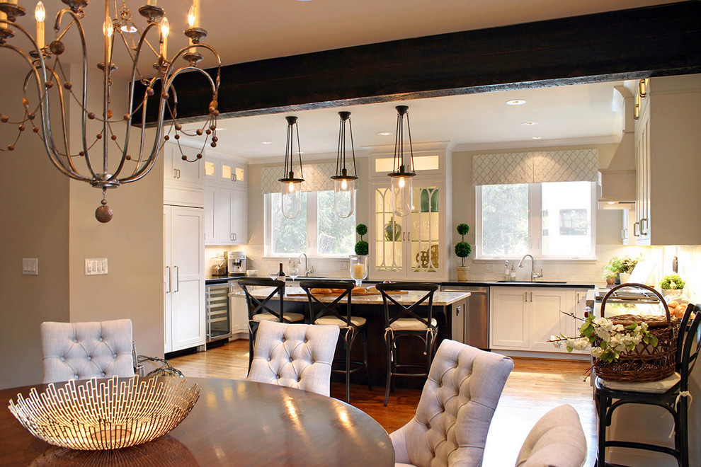 Example of a large transitional medium tone wood floor kitchen design in Houston with an undermount sink, recessed-panel cabinets, an island, granite countertops, white backsplash, subway tile backsplash and stainless steel appliances