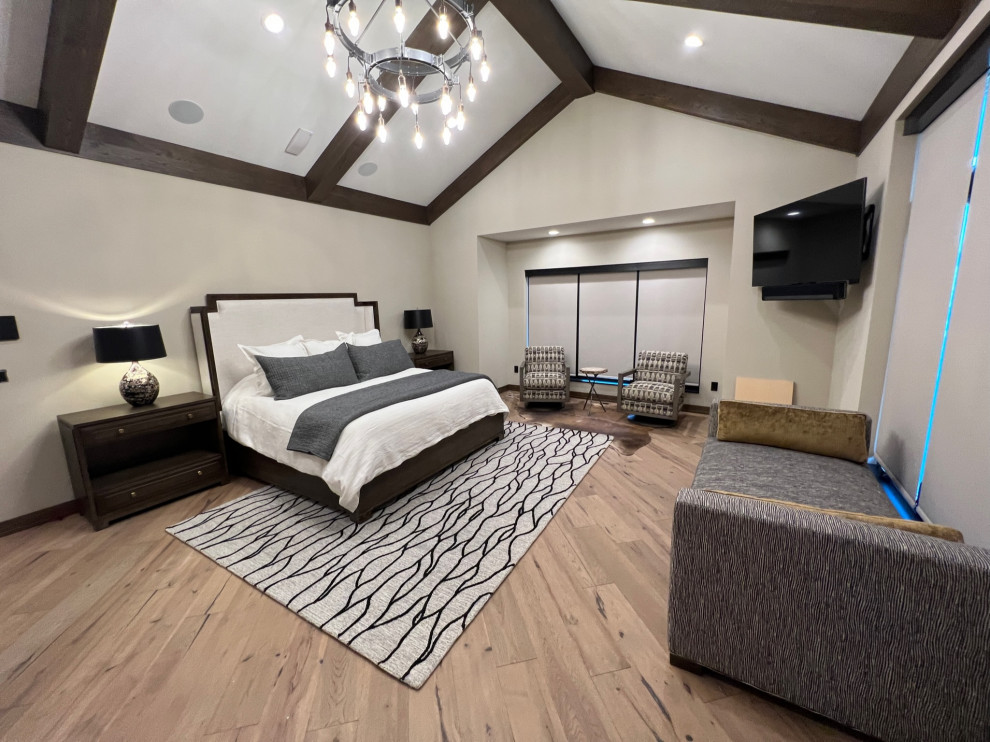 Inspiration for a large modern master bedroom in Milwaukee with beige walls, medium hardwood flooring, brown floors and a vaulted ceiling.