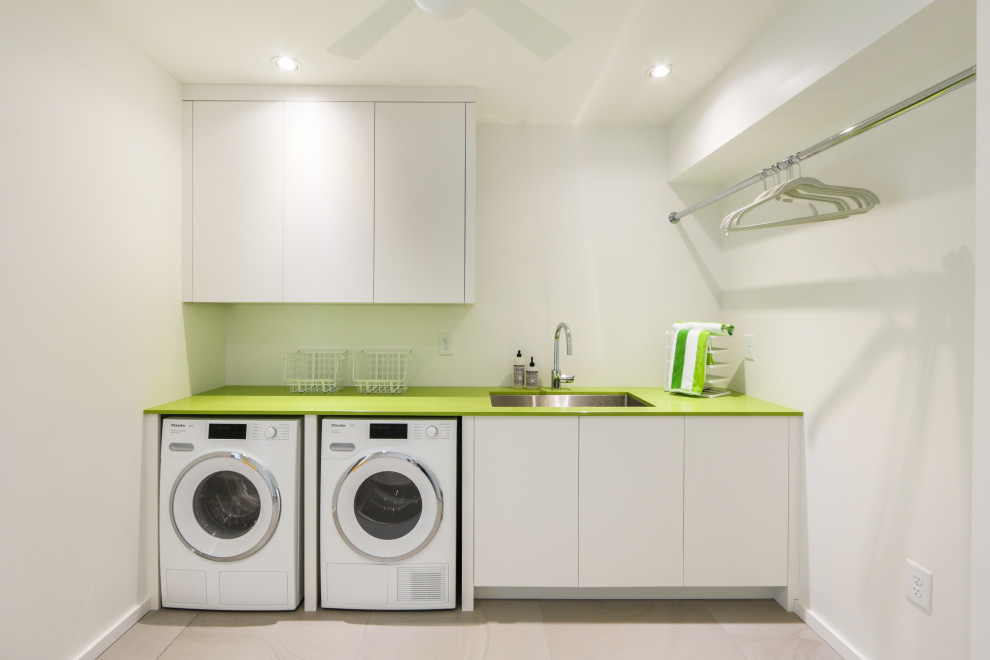 Design ideas for a small contemporary single-wall dedicated laundry room in Atlanta with an undermount sink, flat-panel cabinets, white cabinets, solid surface benchtops, white walls, a side-by-side washer and dryer, beige floor, green benchtop and porcelain floors.