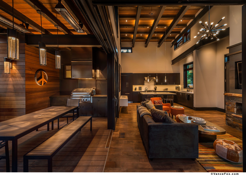 Example of a large trendy backyard patio kitchen design in Sacramento with decking and a roof extension