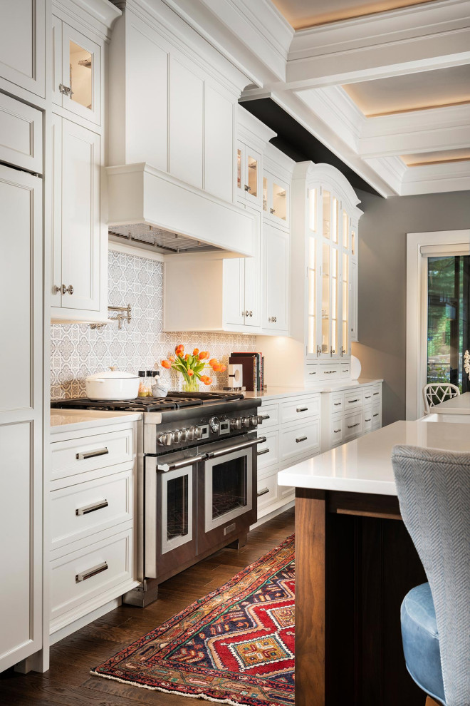 This is an example of an expansive traditional single-wall open plan kitchen in Other with white cabinets, quartzite benchtops, medium hardwood floors, with island, white benchtop and coffered.