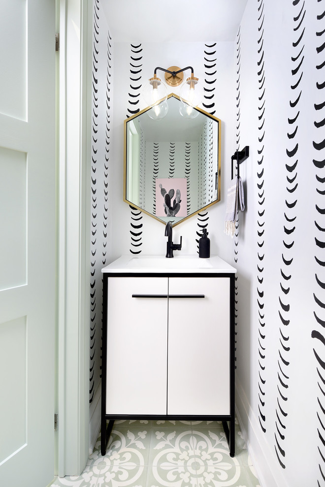 Mid-sized contemporary powder room in Toronto with furniture-like cabinets, white cabinets, cement tiles, green floor, white benchtops, white walls and a console sink.