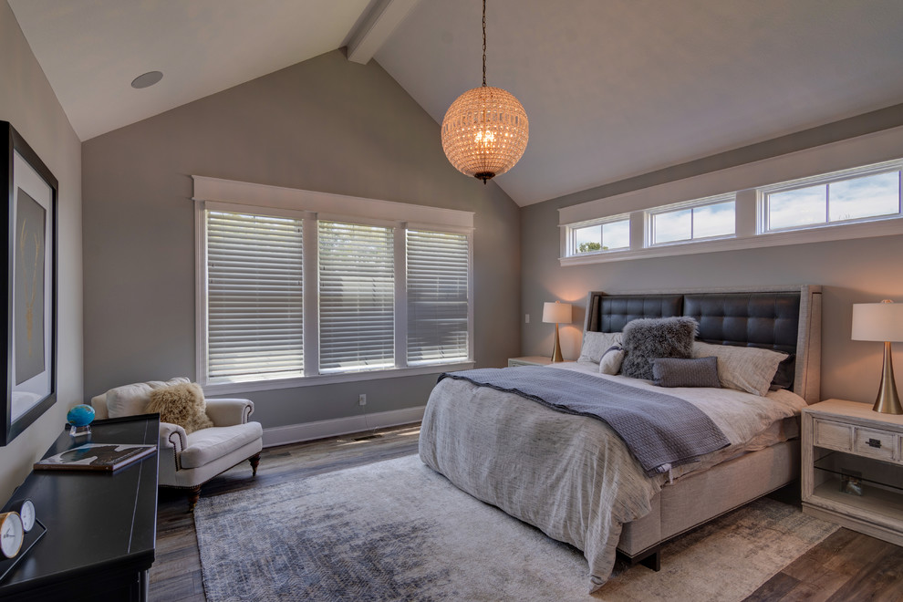 Design ideas for a mid-sized eclectic master bedroom in Indianapolis with beige walls, vinyl floors, no fireplace and brown floor.
