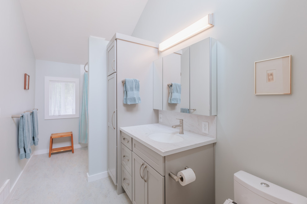 Design ideas for a mid-sized transitional master bathroom in Portland with shaker cabinets, beige cabinets, an alcove tub, a shower/bathtub combo, a bidet, blue walls, engineered quartz benchtops, grey floor, a shower curtain, white benchtops, a single vanity and a built-in vanity.
