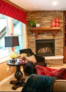 Mid-sized transitional underground carpeted basement photo with beige walls, a standard fireplace and a stone fireplace