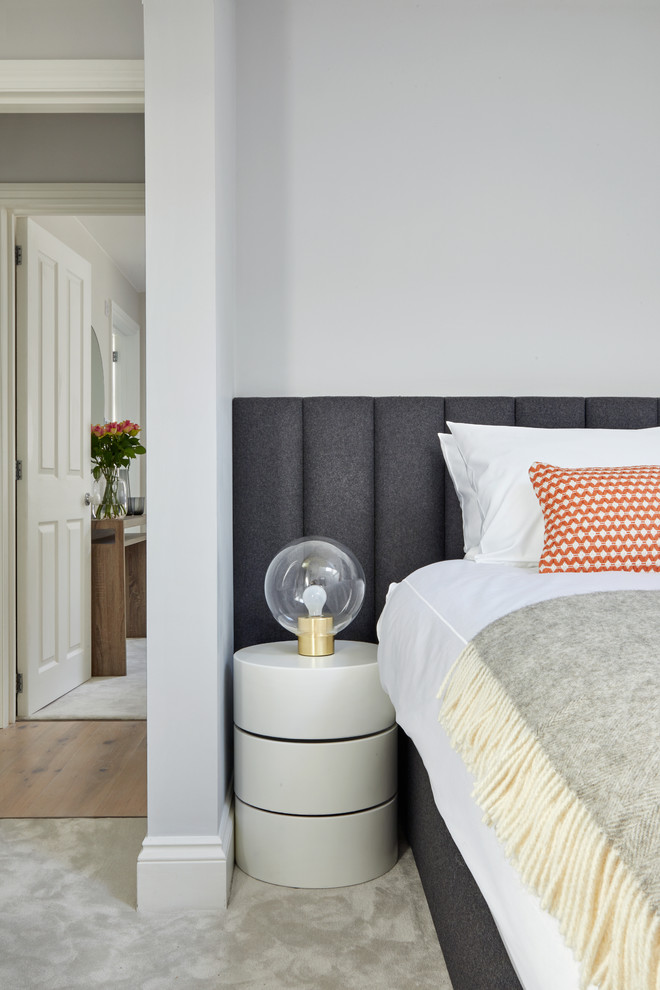 Inspiration for a modern guest bedroom in London with grey walls, carpet and grey floor.