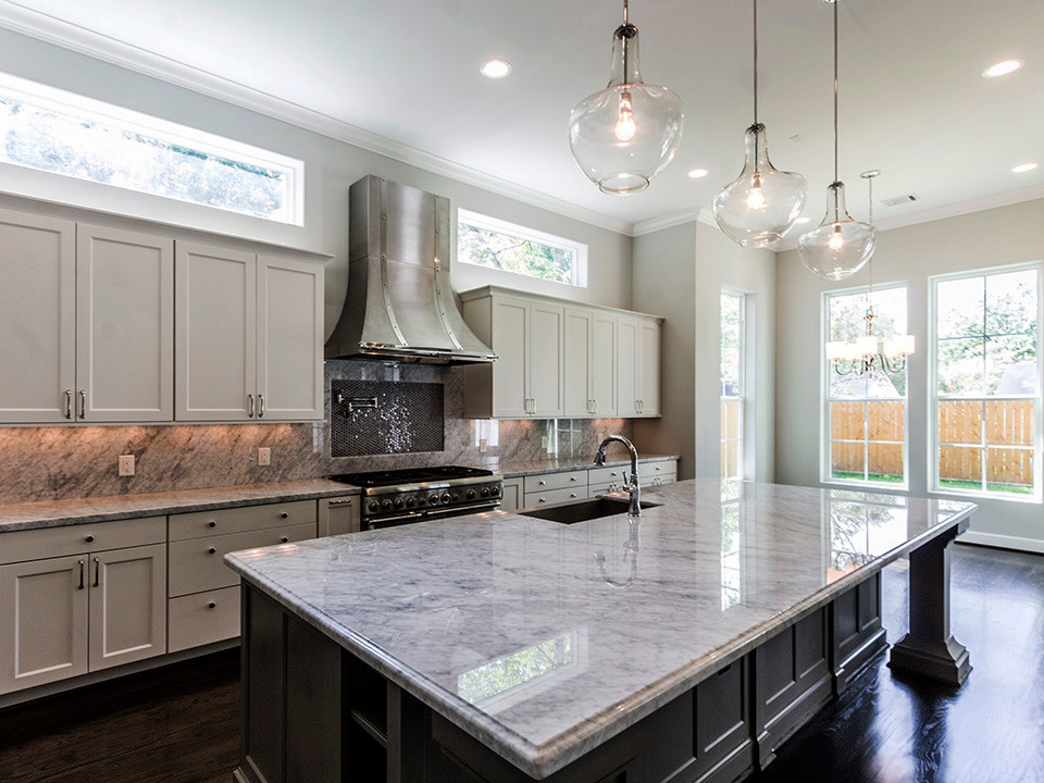 Open concept kitchen - large transitional dark wood floor open concept kitchen idea in Houston with a farmhouse sink, shaker cabinets, white cabinets, marble countertops, stone slab backsplash, stainless steel appliances and an island