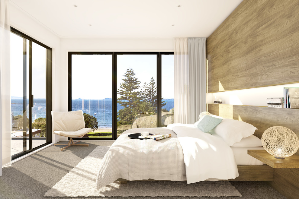 Design ideas for a mid-sized contemporary master bedroom in Auckland with white walls, carpet and grey floor.