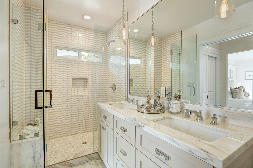 Inspiration for a small transitional master bathroom in Los Angeles with recessed-panel cabinets, grey cabinets, an alcove shower, white walls, an undermount sink, beige tile, marble benchtops and a hinged shower door.