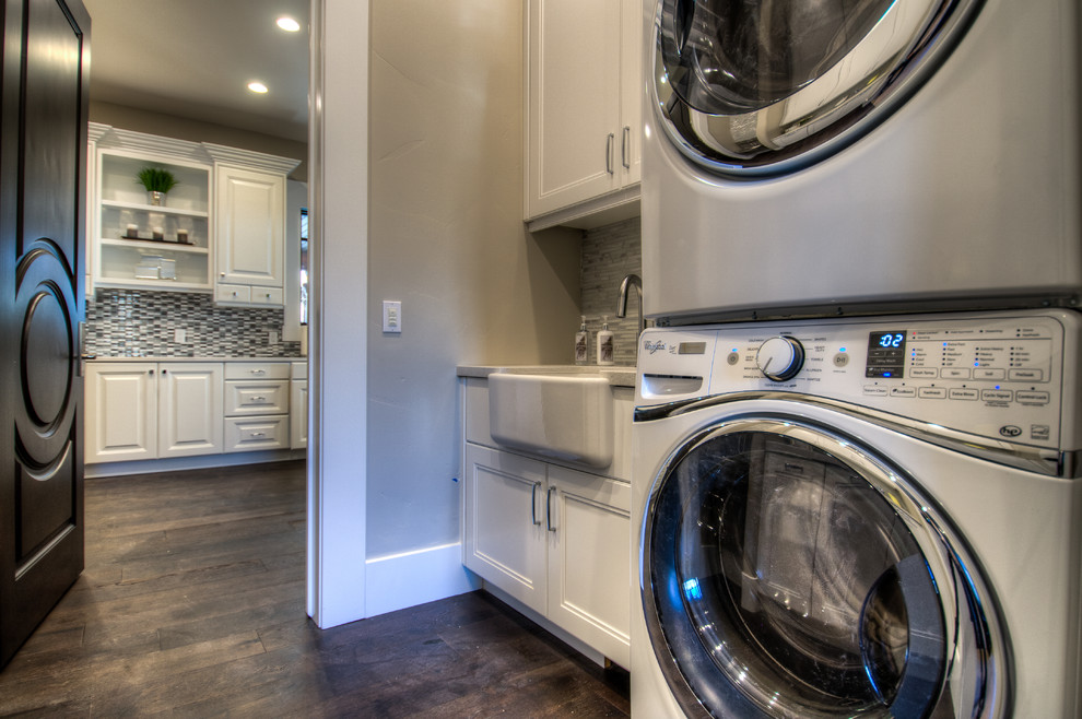 Design ideas for a small traditional galley utility room in Salt Lake City with a farmhouse sink, recessed-panel cabinets, white cabinets, quartz benchtops, grey walls, dark hardwood floors and a side-by-side washer and dryer.