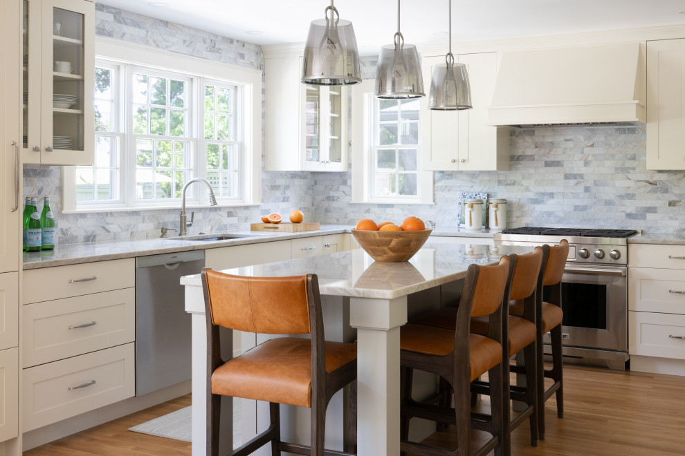 Inspiration for a transitional kitchen remodel in Boston with shaker cabinets, beige cabinets, quartzite countertops, gray backsplash, marble backsplash, an island and gray countertops