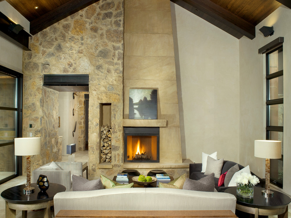 Inspiration for a country formal open concept living room in Denver with beige walls, a standard fireplace, a stone fireplace surround and no tv.