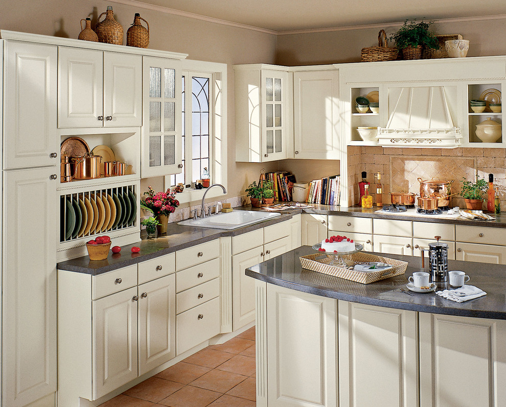 Mid-sized traditional l-shaped separate kitchen in Minneapolis with a drop-in sink, raised-panel cabinets, white cabinets, laminate benchtops, beige splashback, stone tile splashback, terra-cotta floors and with island.