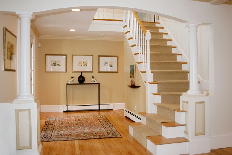 Entryway - mid-sized transitional medium tone wood floor and brown floor entryway idea in Orange County with beige walls