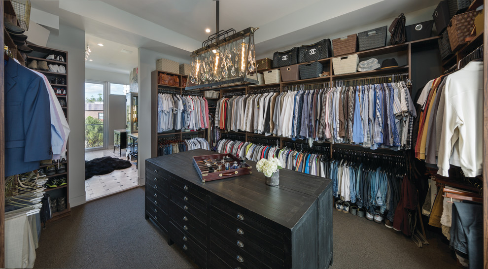 This is an example of a large transitional men's walk-in wardrobe in Miami with carpet.