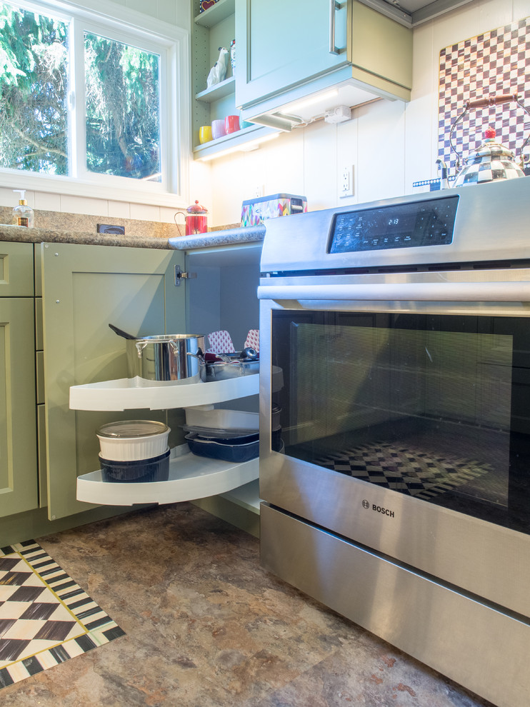 Enclosed kitchen - small transitional u-shaped vinyl floor enclosed kitchen idea in Seattle with a drop-in sink, recessed-panel cabinets, green cabinets, laminate countertops, brown backsplash, stainless steel appliances, no island and brown countertops