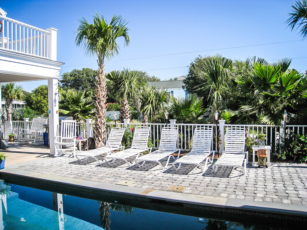 Inspiration for a large beach style courtyard rectangular natural pool in Charleston with concrete pavers.