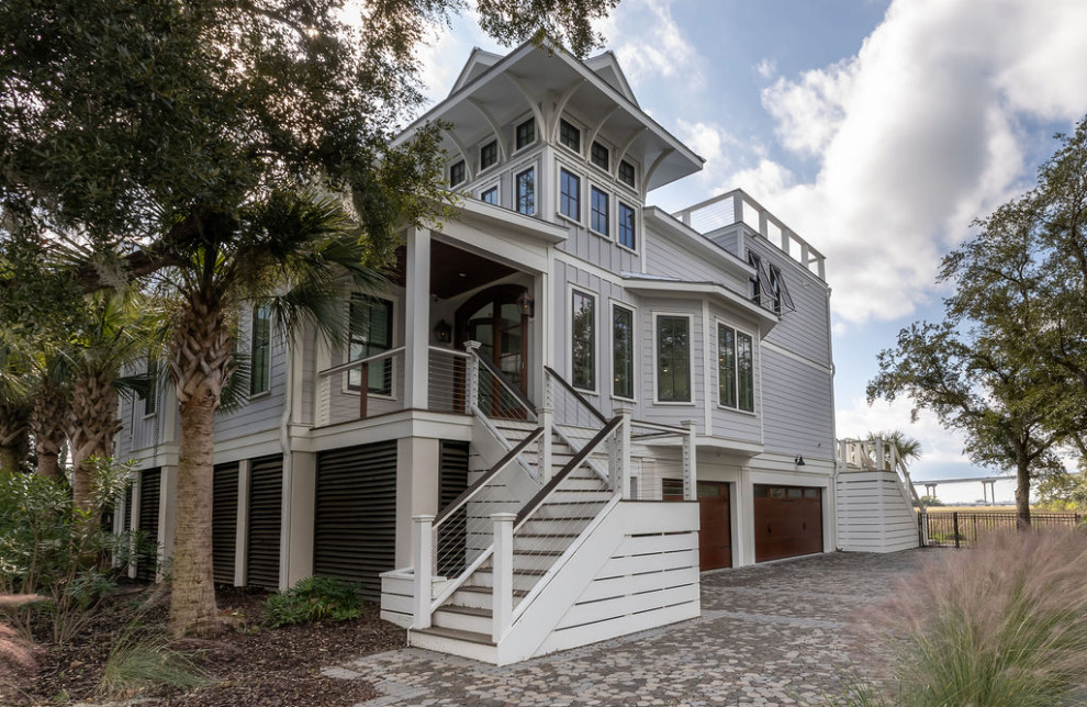 Example of a beach style home design design in Charleston