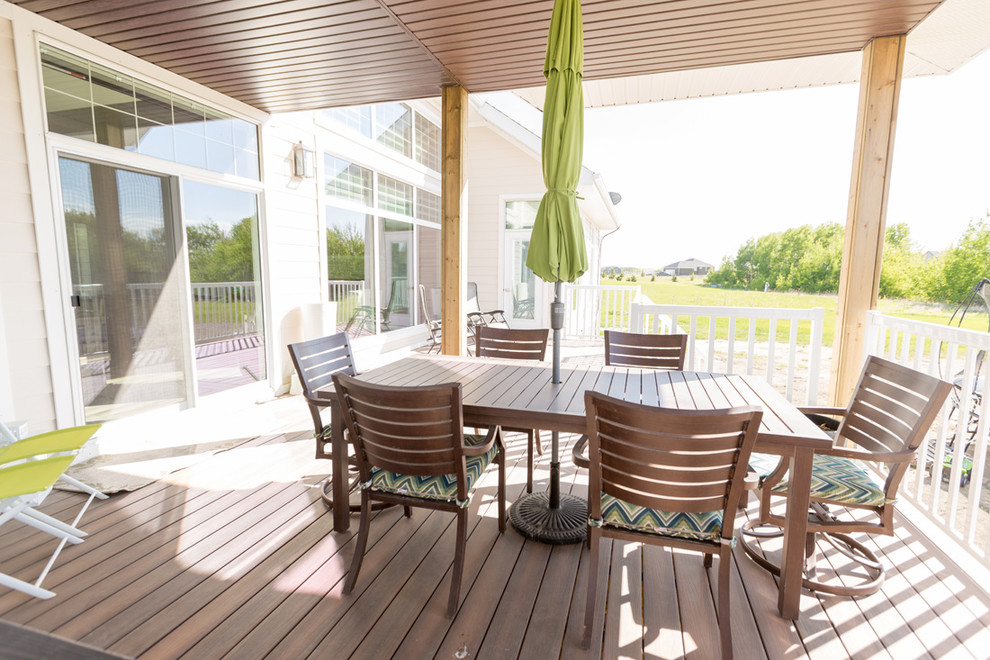 Inspiration for a transitional backyard patio remodel with decking and a roof extension