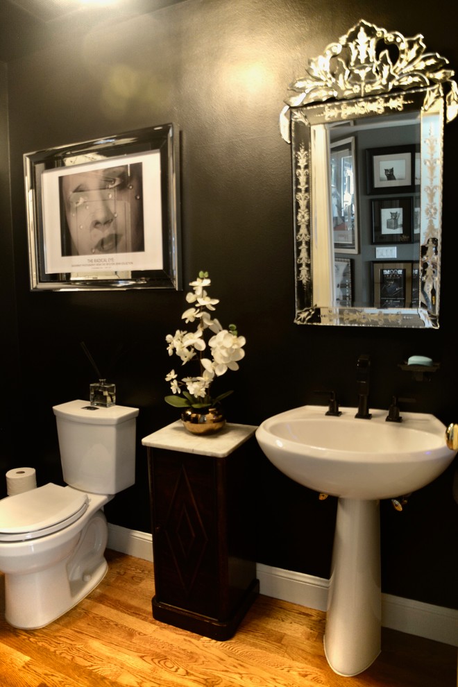 Mid-sized contemporary powder room in San Francisco with black tile, black walls and light hardwood floors.