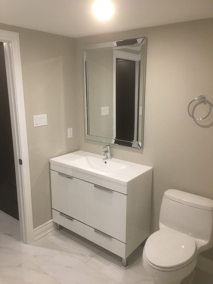 Design ideas for a mid-sized modern 3/4 bathroom in Toronto with flat-panel cabinets, white cabinets, engineered quartz benchtops, an alcove shower, a shower curtain, a one-piece toilet, marble, beige walls, marble floors, an integrated sink, white floor and white tile.