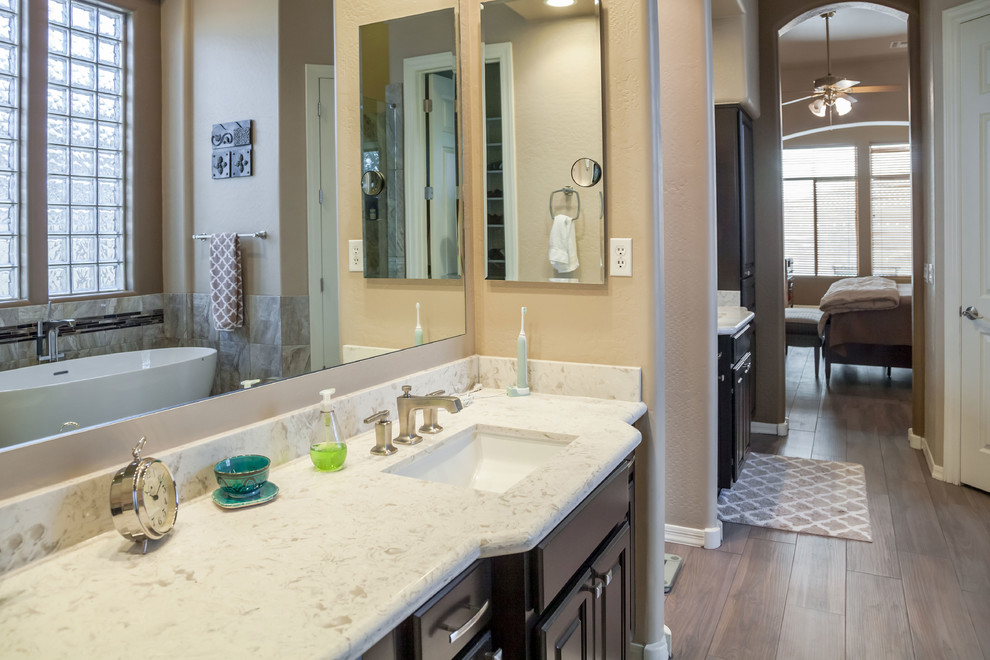 Bedroom - transitional master porcelain tile bedroom idea in Phoenix with beige walls