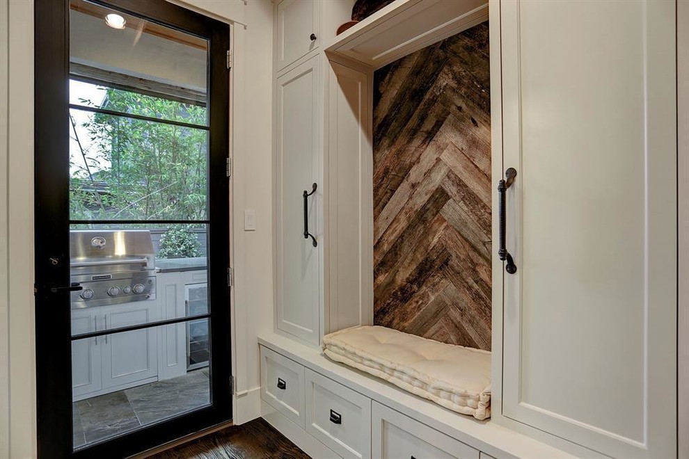 Inspiration for a large traditional mudroom in Houston with white walls, dark hardwood floors, a single front door, a dark wood front door and brown floor.