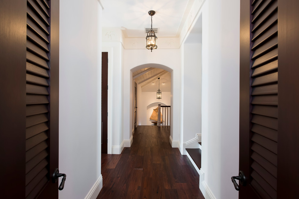 Mid-sized contemporary hallway in Miami with white walls, dark hardwood floors and brown floor.